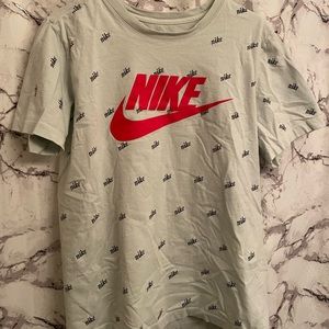 Nike t shirt with little black Nikes all over front and back